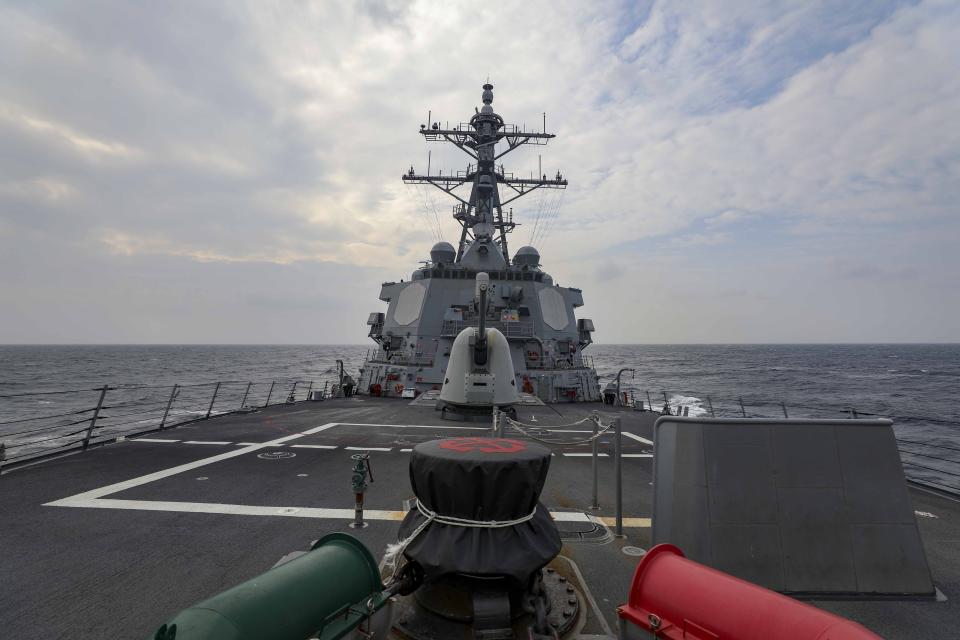 In this photo provided by U.S. Navy, The guided-missile destroyer USS Higgins (DDG 76) conducts a routine Taiwan Strait transit Sept. 20, 2022. China toned down its rhetoric on Taiwan on Wednesday, Sept. 21, saying it is inevitable that the self-governing island comes under its control but that it would promote efforts to achieve that peacefully. The comments came one day after the U.S. and Canadian navies sailed through the strait between China and Taiwan. (Mass Communication Specialist 1st Class Donavan K. Patubo/U.S.Navy via AP)