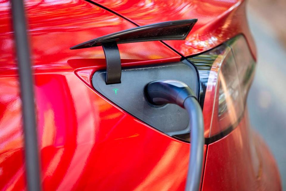 A Tesla charges at an electric charging station at North Hills in Raleigh Tuesday, October. 17, 2023. Electric vehicle owners will see an increase in both new vehicle and annual registration fees.
