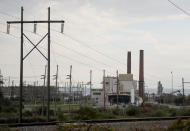 Smokestacks from the Greenridge Generation power plant tower above the surrounding landscape, Friday, Oct. 15, 2021, in Dresden, N.Y. One Bitcoin mining operation in central New York came up with a novel solution in finding cheap energy to run the power-gobbling computer arrays that create and transact cryptocurrency: It took over Greenidge Generation which now produces about 44 megawatts to run 15,300 computer servers, plus additional electricity it sends into the state's power grid. (AP Photo/Julie Jacobson)