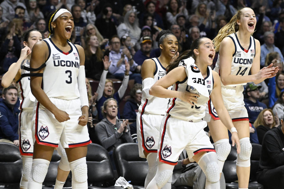 UConn's Aaliyah Edwards, Aubrey Griffin, Nika Muhl, and Dorka Juhasz, from left cheer during the second half of an NCAA college basketball game against Marquette in the semifinals of the Big East Conference tournament at Mohegan Sun Arena, Sunday, March 5, 2023, in Uncasville, Conn. (AP Photo/Jessica Hill)