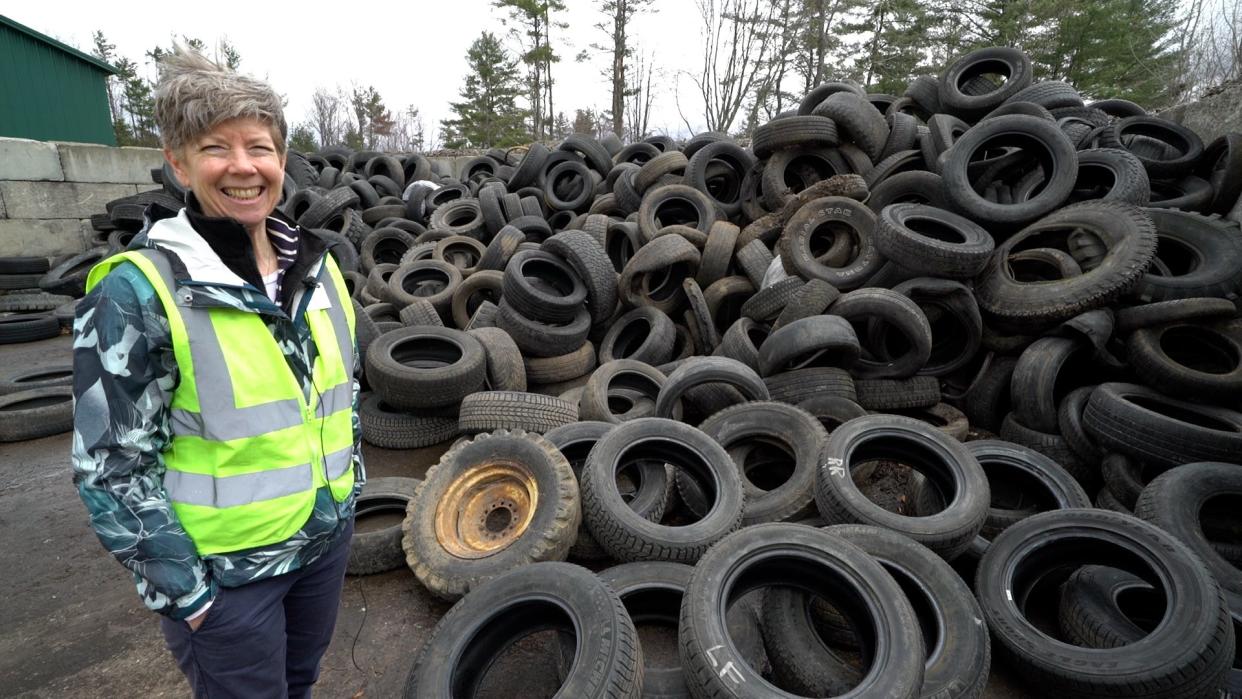 Michele Morris of Chittenden Solid Waste District stands next to a pile of tires at CSWD's Williston drop-off center. Tires cannot go in the trash or the blue recycling bin in Vermont. They can be brought to CSWD drop-off centers.