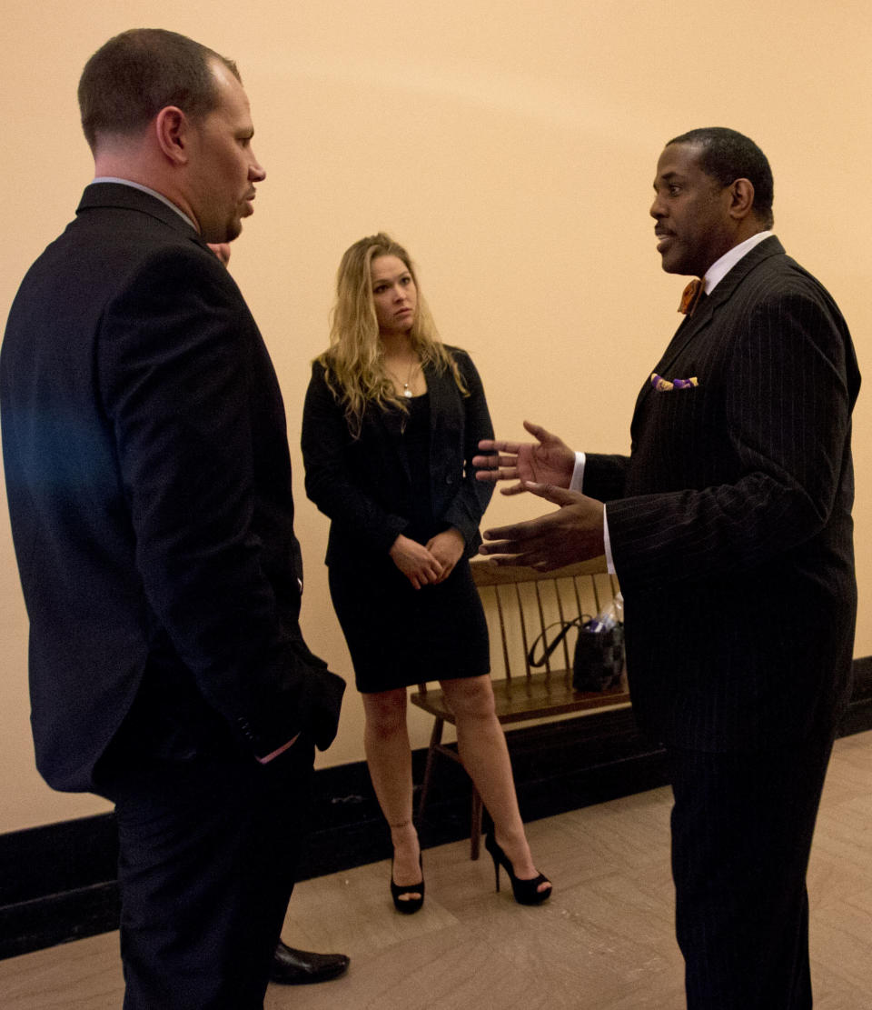 Sen. Kevin Parker, D-Brooklyn, right talks with mixed martial arts athletes Ronda Rousey, center, and Nick Catone at the Capitol in Albany, N.Y., on Wednesday, April 18, 2012. The state Senate is expected to approve legislation again to make New York the 46th state to legalize and regulate the sport, though opposition remains in the state Assembly. (AP Photo/Mike Groll)