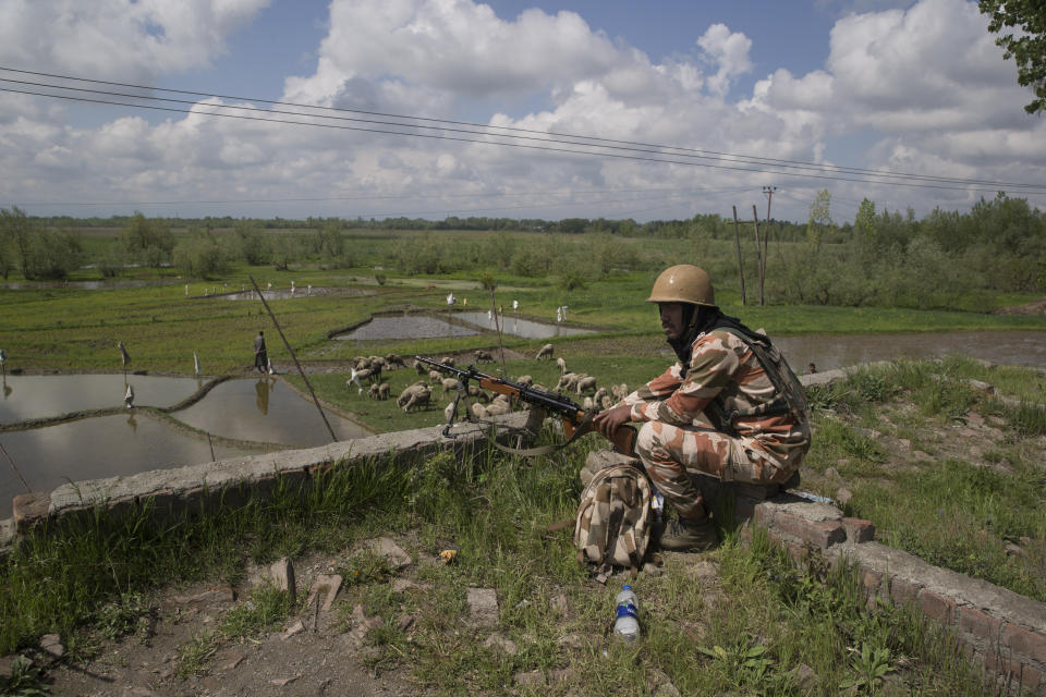 An Indian paramilitary soldier rests on a road leading to polling station during the second phase of India's general elections, in Ganderbal, about 20 kilometers (12 miles) north east of Srinagar, Indian controlled Kashmir, Thursday, April 18, 2019. Kashmiri separatist leaders who challenge India's sovereignty over the disputed region have called for a boycott of the vote. Most polling stations in Srinagar and Budgam areas of Kashmir looked deserted in the morning with more armed police, paramilitary soldiers and election staff present than voters. (AP Photo/ Dar Yasin)