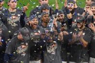 Oct 21, 2017; Houston, TX, USA; Houston Astros second baseman Jose Altuve (27) holds up the trophy after game seven of the 2017 ALCS playoff baseball series between the Houston Astros and the New York Yankees at Minute Maid Park. Shanna Lockwood-USA TODAY Sports