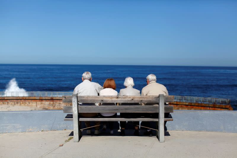 FILE PHOTO: Older couples view the ocean and waves along the beach in La Jolla