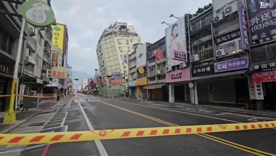 In this image from a video, roads in Hualien, Taiwan are cordoned off after a cluster of earthquakes struck the island early Tuesday, April 23, 2024. There were no reports of casualties in the quakes, although there were further damages to two multi-story buildings that had been evacuated following a magnitude 7.4 quake that hit the island earlier this month, killing 13 people and injuring over 1,000. (TVBS via AP)