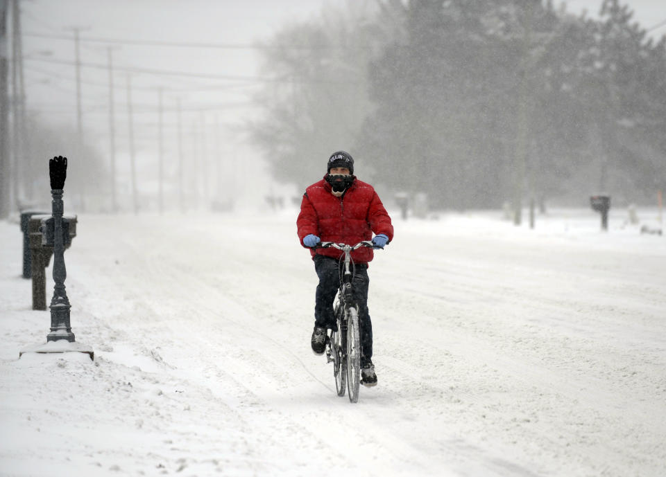 Jordan Beaudrie rides his bike in the snow in St. Clair Shores, Mich., Thursday, Jan. 2, 2014. A multi-day storm dropped up to a foot of snow on parts of Michigan, causing crashes and spinouts on roadways. Snowfall began Tuesday and continued Thursday morning. (AP Photo/Detroit News, David Coates) DETROIT FREE PRESS OUT; HUFFINGTON POST OUT, MADATORY CREDIT