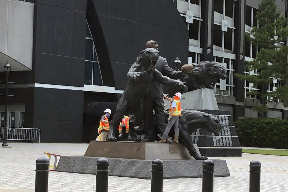 A work crew prepares to remove a statue of former Carolina Panthers owner Jerry Richardson from in front of the team's stadium in Charlotte, N.C., Wednesday, June 10, 2020. “We were aware of the most recent conversation surrounding the Jerry Richardson statue and are concerned there may be attempts to take it down," the team said in a statement. "We are moving the statue in the interest of public safety.” (AP Photo/Steve Reed)