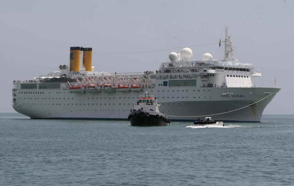 The Costa Allegra Cruise ship is towed in the Victoria's harbor, Seychelles Island, Thursday, March 1, 2012. The disabled cruise ship arrived in port in the island nation of the Seychelles on Thursday morning after three days at sea without power. (AP Photo/Gregorio Borgia)