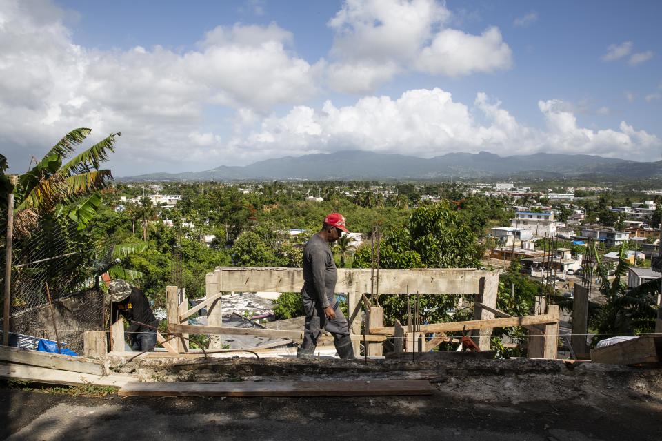 Workers rebuild a home in Villa Hugo 2 nearly a year after the storm.&nbsp; (Photo: Carolina Moreno/HuffPost)