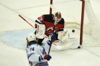 New York Rangers' Vitali Kravtsov, left, scores on New Jersey Devils goaltender Mackenzie Blackwood during the first period of the NHL hockey game in Newark, N.J., Sunday, April 18, 2021. (AP Photo/Seth Wenig)