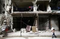 FILE PHOTO: A boy is seen in the besieged town of Douma, Eastern Ghouta, in Damascus