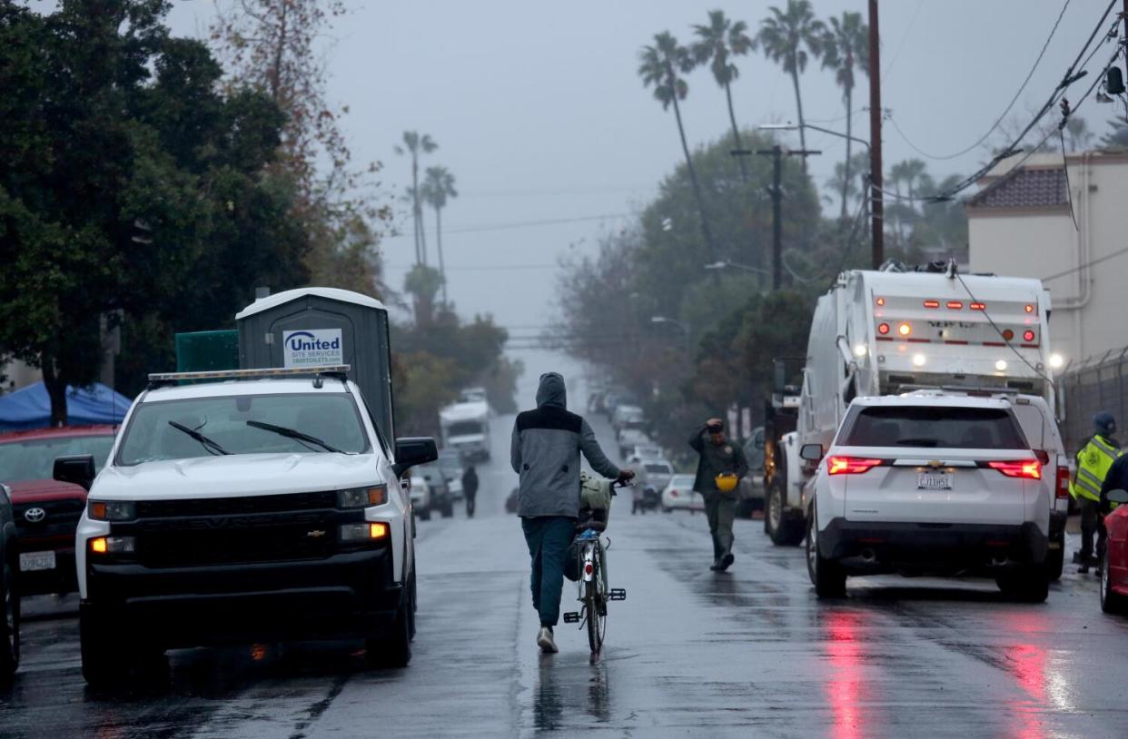 A bicyclist walks along Hampton Avenue in Venice in January.