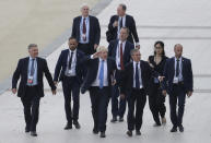 FILE - In this Monday, Aug. 26, 2019 file photo Britain's Prime Minister Boris Johnson, center, salutes people as he walks along the seafront in Biarritz, France ahead of the third and final day of the G-7 summit, . (AP Photo/Markus Schreiber)