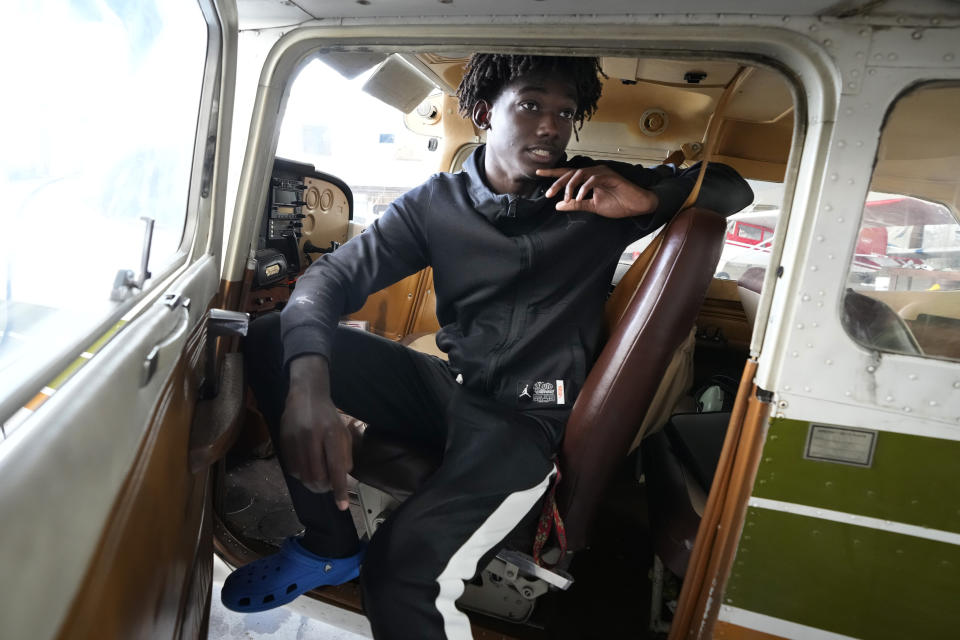 Jibril Hamad, 17, of Detroit, sits in a Cessna, Thursday, Aug. 17, 2023, at the Coleman A. Young airport in Detroit. Hamad has his future mapped out in paths measured not by miles, but by altimeters. The Detroit teen is part of a program that teaches young people how to fly, while exposing them to careers in aviation and as pilots...areas people of color traditionally are underrepresented. (AP Photo/Carlos Osorio)