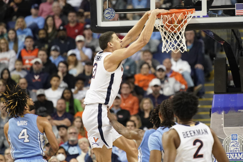 Virginia forward Kadin Shedrick (21), center, dunks against North Carolina during the second half of an NCAA college basketball game at the Atlantic Coast Conference Tournament in Greensboro, N.C., Thursday, March 9, 2023. (AP Photo/Chuck Burton)