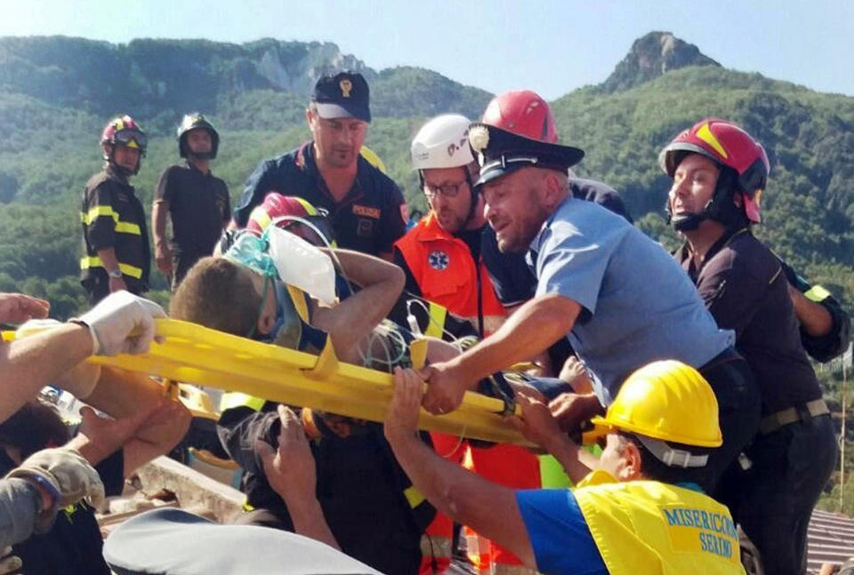 <p>Firefighters and rescuers pull out a boy, Mattias, from the collapsed building in Casamicciola, on the island of Ischia, near Naples, Italy, a day after a 4.0-magnitude quake hit the Italian resort island, Tuesday, Aug. 22, 2017. (Photo: Italian Carabinieri, HO/ANSA via AP) </p>