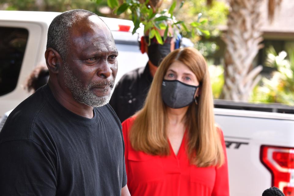 Crosley Green, standing with one of his pro bono attorneys Jeane Thomas, talks to the media outside the federal probation office in Cocoa last year.