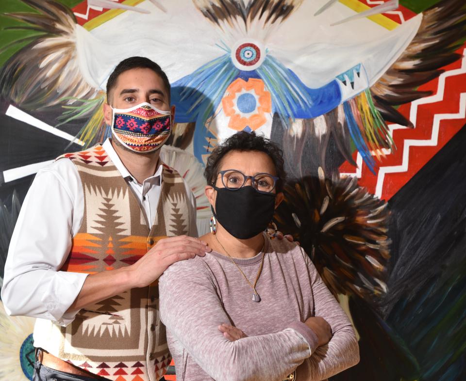 In 2020, Mashpee Wampanoag Paula Peters and her son Steven beside a painting entitled "Three Sisters" by Mashpee Wampanoag artist Natasha Frye.