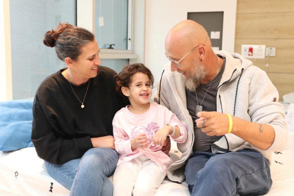 Abigail Edan, who was released after being taken hostage during the Oct. 7 attack on Israel by the Palestinian militant group Hamas, talks with her aunt Liron and uncle Zuli at Schneider Children's Medical Center of Israel in Petah Tikva, Israel, on Nov. 27, 2023. / Credit: Schneider Children's Medical Center of Israel/Handout via REUTERS