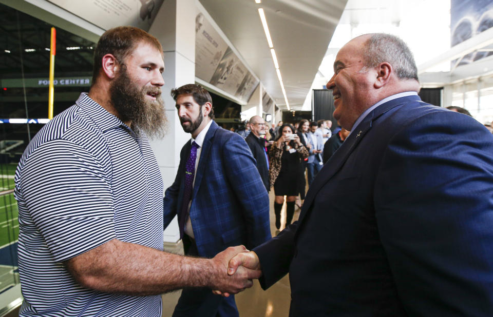 New Dallas Cowboys head coach Mike McCarthy, right, greets player Travis Frederick after a press conference at the Dallas Cowboys headquarters Wednesday, Jan. 8, 2020, in Frisco, Texas. (AP Photo/Brandon Wade)