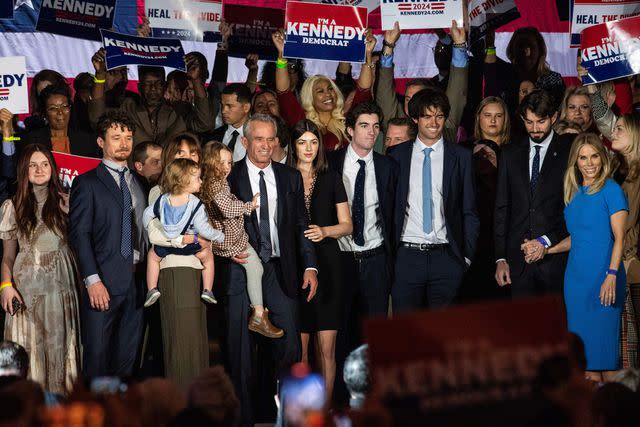 JOSEPH PREZIOSO/AFP via Getty Obert F Kennedy Jr. (4th from left), his wife Cheryl Hines (right) and family members in Boston on April 19, 2023