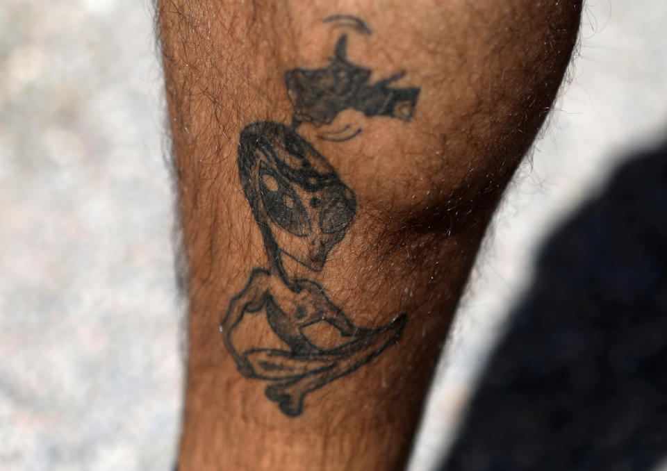 An attendee shows an alien themed tattoo as an influx of tourists responding to a call to 'storm' Area 51, a secretive U.S. military base believed by UFO enthusiasts to hold government secrets about extra-terrestrials, is expected in Rachel, Nevada, Sept. 19, 2019. (Photo: Jim Urquhart/Reuters)