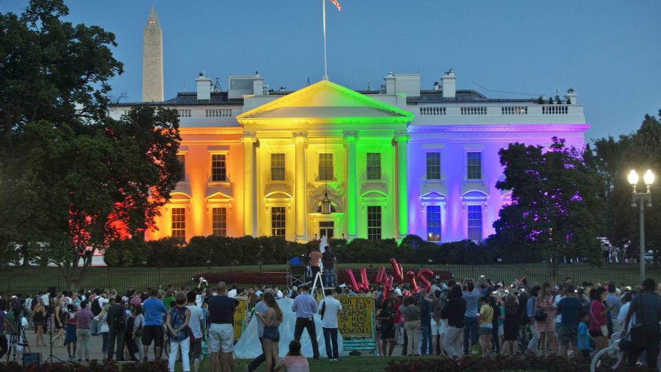 June 26, 2015 file photo, people gather in Lafayette Park to see the White House illuminated with rainbow colors in commemoration of the Supreme Court's ruling to legalize same-sex marriage in Washington. It was a new look for the White House: illuminated in rainbow colors to celebrate the Supreme Court decision allowing same-sex marriage nationwide