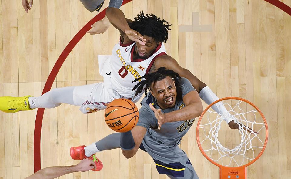 Iowa State forward Tre King (0) defends as West Virginia forward Josiah Harris (22) attempts to take a shot on Feb. 24 in Ames, Iowa.