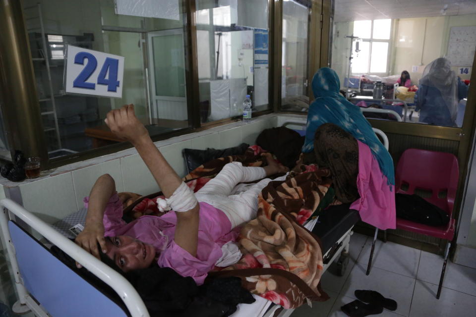 In this Tuesday, Feb. 19, 2019, photo, an Afghan woman who was burned in a domestic violence attack, receives treatment at a hospital in Herat, Afghanistan. Women have made gains since the 2001 fall of the Taliban, but the country remains almost the worst places in the world to be a woman. Activists fear the advances they have achieved will be bargained away in negotiations, with pressure heavy for a deal as the United States seeks to end its military involvement in the country.(AP Photo/Rahmat Gul)