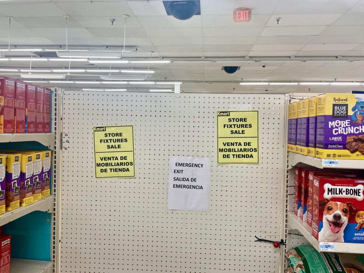Sign advertising sale of Kmart fixtures inside the store