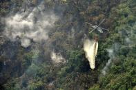 <p>Un hélicoptère déverse de l'eau sur un incendie à Cali. </p>