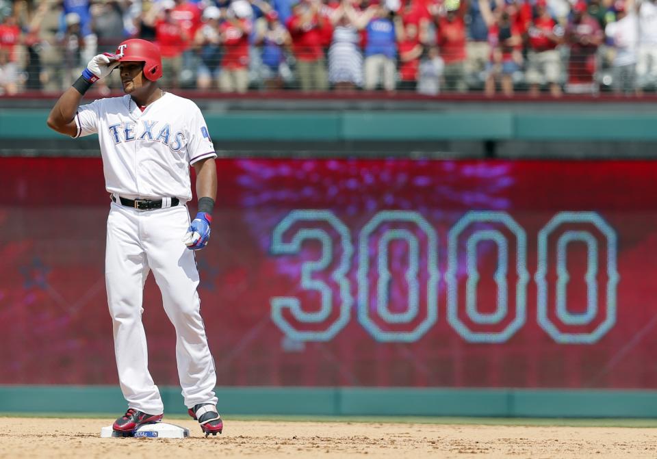 Texas Rangers' Adrian Beltre tips his helmet as he acknowledges cheers after hitting a double for his 3,000th career hit that came off a pitch from Baltimore Orioles' Wade Miley in the fourth inning of a baseball game, Sunday, July 30, 2017, in Arlington, Texas.