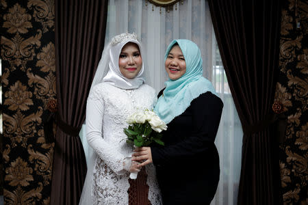 A wedding photo of the bride of a Lion Air flight JT610 victim, who carried on the celebration despite the absence of the groom, in Bangka, Bangka Belitong Province, Indonesia November 11, 2018 in this picture obtained from social media on November 16, 2018. LALA INDRA PERMANA/via REUTERS