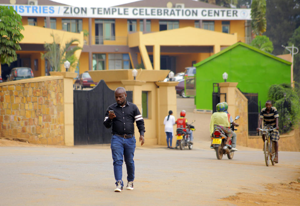 In this photo taken Friday Sept. 6, 2019, Albert Nabonibo, a well-known gospel singer in Rwanda, walks out from the Church of Zion temple celebration centre in Kigali, Rwanda. Nabonibo shocked many last month when he revealed he is a gay man in a country where such a public assertion of homosexuality is unheard of. (AP Photo/Olivier Muhizi)