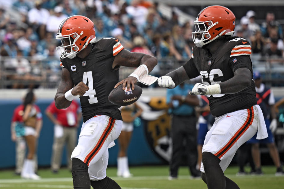 Cleveland Browns quarterback Deshaun Watson (4) celebrates his one-yard touchdown run with offensive tackle James Hudson III (66) during the first half of an NFL football game Sunday, Sept. 15, 2024, in Jacksonville, Fla. (AP Photo/Phelan M. Ebenhack)