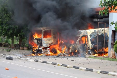 An ambulance and a fire engine set on fire by a Shi'ite group are seen at the Federal Secretariat in Abuja