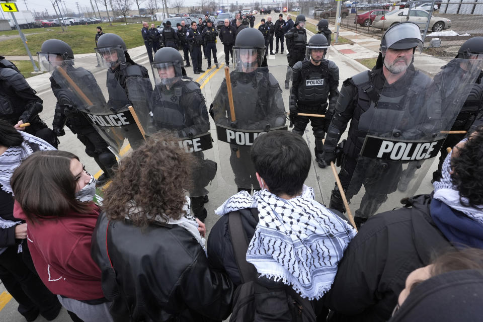 Pro-Palestinian demonstrators march against police during a visit by President Joe Biden in Warren, Mich., Thursday, Feb. 1, 2024. (AP Photo/Paul Sancya)