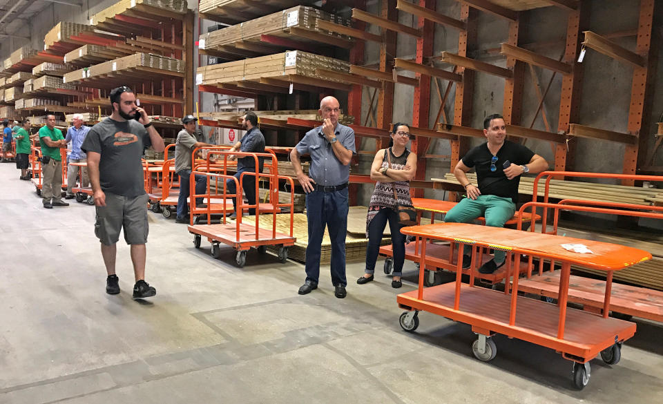 Shoppers in a Home Depot store wait for plywood in the Little Havana neighborhood in Miami.