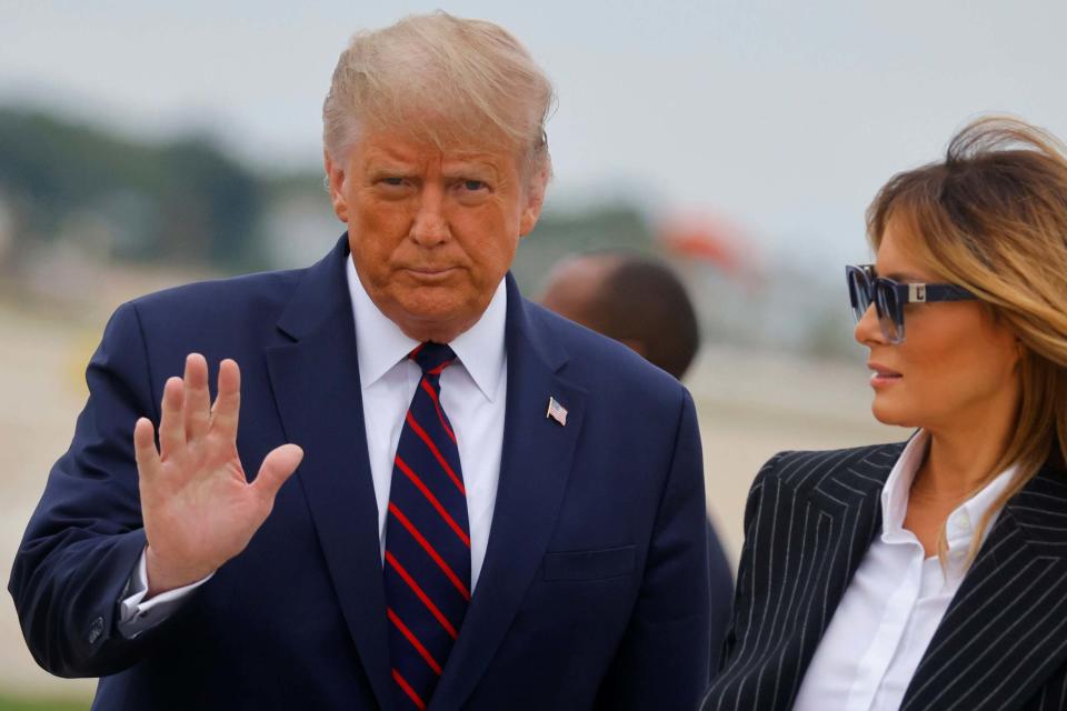 US President Donald Trump walks with first lady Melania Trump at Cleveland Hopkins International Airport in Cleveland (Reuters)