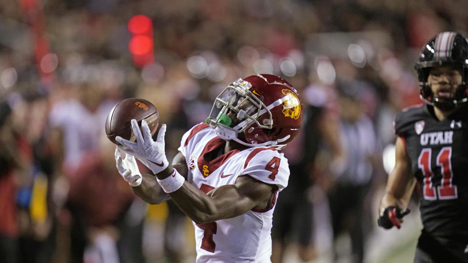 Southern California's Mario Williams catches as pass next to Utah safety R.J. Hubert (11) during the first half of an NCAA college football game Saturday, Oct. 15, 2022, in Salt Lake City. (AP Photo/Rick Bowmer)