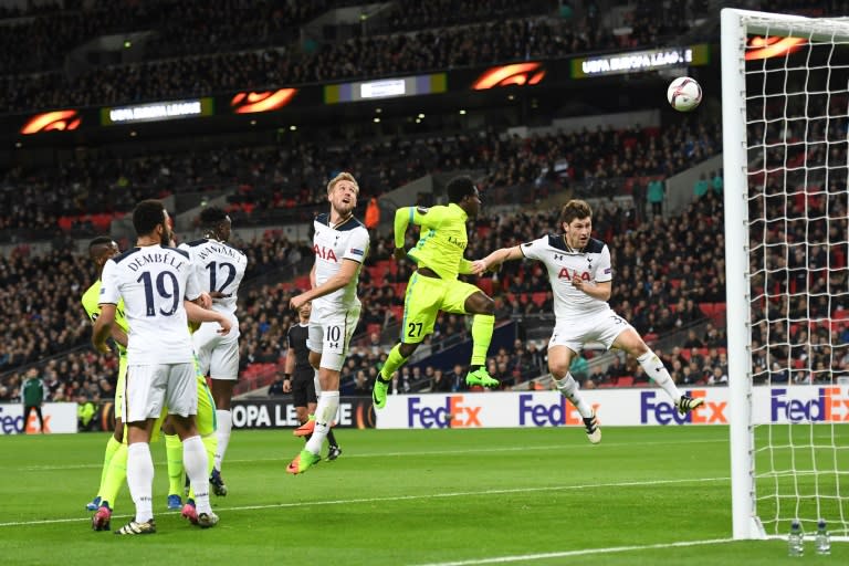 Tottenham Hotspur's striker Harry Kane (C) watches as his defensive header goes into his own goal to score an own goal to level the scores 1-1 during the UEFA Europa League football match between Tottenham Hotspur and KAA Gent on February 23, 2017