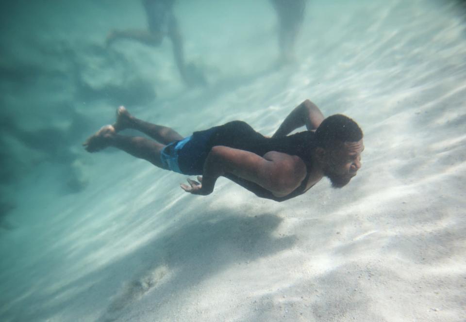 A man swims off Eton Beach on November 30, 2019 in Efate, Vanuatu.