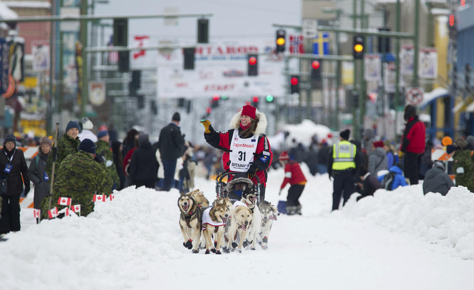 FILE - In this March 3, 2018, file photo, musher Aliy Zirkle runs her team during the ceremonial start of the Iditarod Trail Sled Dog Race in Anchorage, Alaska. The world's most famous sled dog race starts Sunday, March 7, 2021, without its defending champion in a contest that will be as much dominated by unknowns and changes because of the pandemic as mushers are by the Alaska terrain. (AP Photo/Michael Dinneen, File)