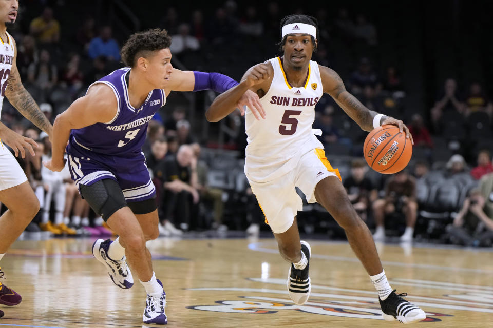 Arizona State guard Jamiya Neal (5) drives on Northwestern guard Ty Berry during the first half of an NCAA college basketball game Wednesday, Dec. 20, 2023, in Phoenix. (AP Photo/Rick Scuteri)