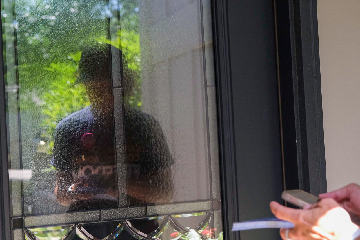 Anne Melia waits at the door while canvassing for Kansans for Constitutional Freedom in Leawood, Kansas on July 23, 2022. Arin Yoon for TIME.