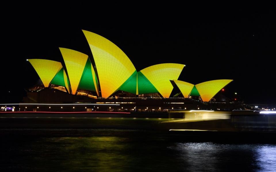 A longtime exposure image shows the sails of the Sydney Opera House being lit up in green and gold ahead of Australia's World Cup match against Argentina - Shutterstock