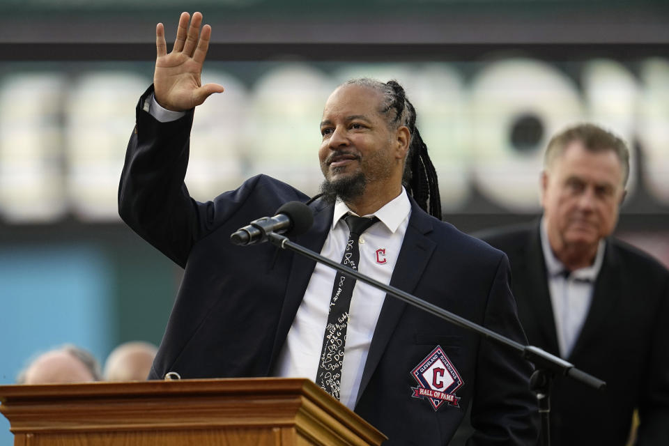 Former Cleveland baseball player Manny Ramirez waves to the crowd during induction ceremonies into the Cleveland Guardians Hall of Fame before a game between the Detroit Tigers and the Guardians, Saturday, Aug. 19, 2023, in Cleveland. (AP Photo/Sue Ogrocki)