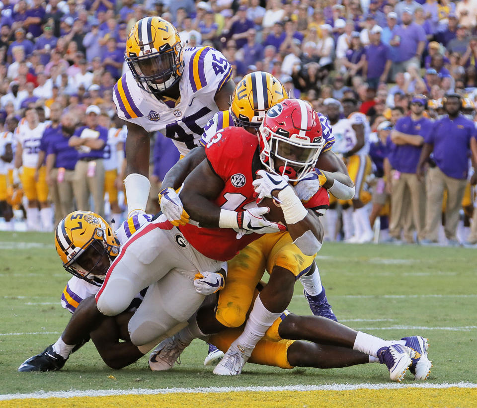 Georgia running back Elijah Holyfield (13) scores against LSU during the third quarter of an NCAA college football game Saturday, Oct. 13, 2018, in Baton Rouge, La. (Bob Andres/Atlanta Journal Constitution via AP)