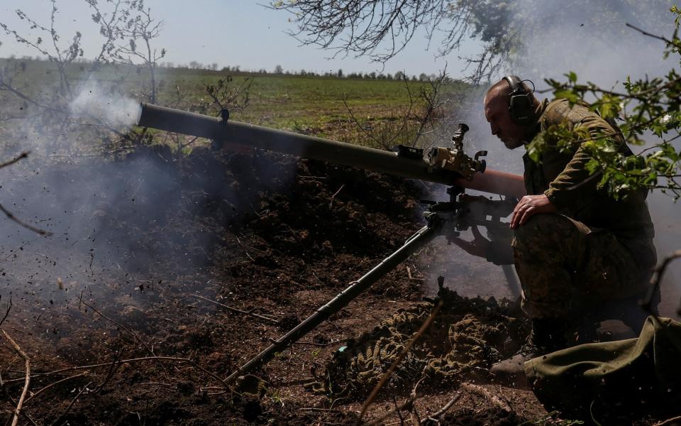 A Ukrainian service member from a 28th separate mechanised brigade named after the Knights of the Winter Campaign of the Armed Forces of Ukraine, fires an anti-tank grenade launcher at a front line, amid Russia's attack on Ukraine, near the city of Bakhmut - Sofiia Gatilova/REUTERS